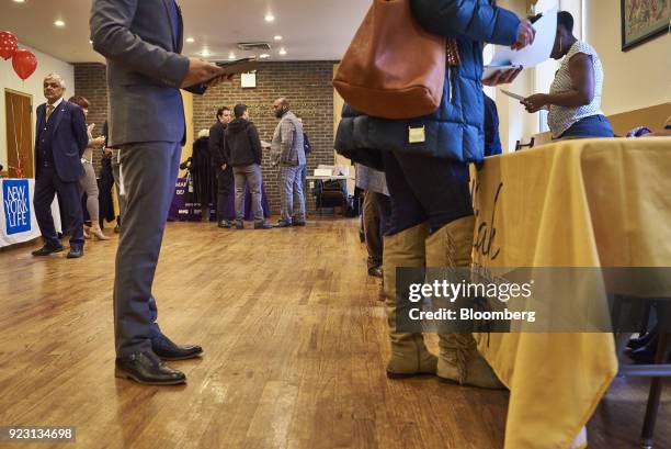 Job seekers wait in line to speak with a representative during a Shades of Commerce Career Fair in the Brooklyn borough of New York, U.S., on...