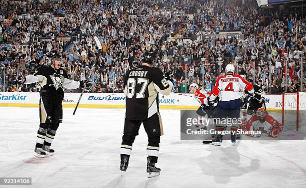Sidney Crosby of the Pittsburgh Penguins celebrates his goal with Evgeni Malkin in front of Dennis Seidenberg of the Florida Panthers on October 23,...