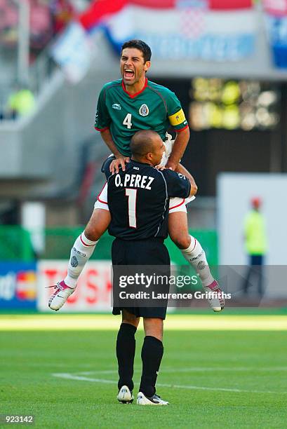 Rarael Marquez of Mexico celebrates with his goalkeeper Oscar Perez after the Mexico goal during the Group G match against Croatia during the World...