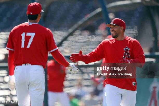 Shohei Ohtani high-fives Rene Rivera of the Los Angeles Angels runs the bases during workouts on Thursday, February 22, 2018 at Tempe Diablo Stadium...