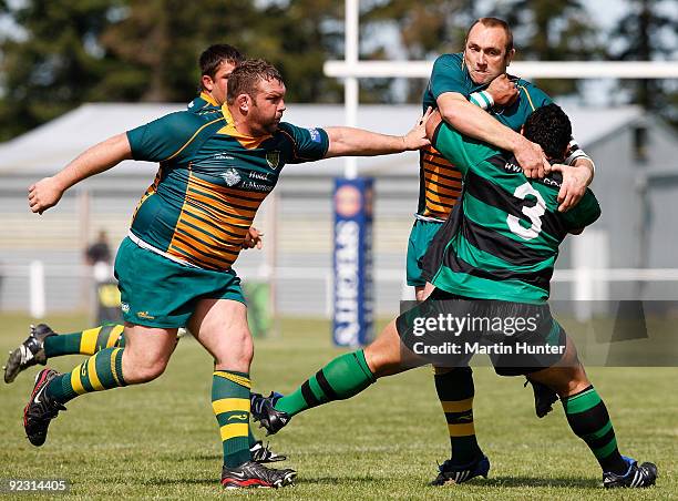 Faianga'a Savieti of South Canterbury is tackled by Pete McAndrew and Jason Rickard of Mid Canterbury during the Heartland Championship Semi-Final...