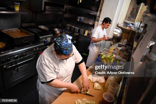 Cooks Kyle Fuchs and Mariela Pacheco prepare their stations as the kitchen staff gets ready for evening service at Bistro Vendome on Thursday,...