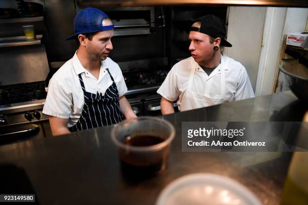 Sous chef Ben Ashworth and cook Kyle Fuchs prepare the evening French classic special as the kitchen staff prepares for evening service at Bistro...