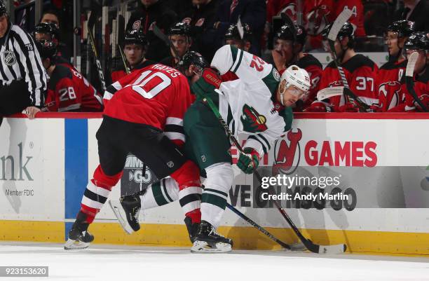 Jimmy Hayes of the New Jersey Devils and Nino Niederreiter of the Minnesota Wild battle for position during the game at Prudential Center on February...