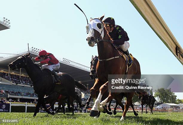 Damien Oliver riding Apache Cat celebrates as he crosses the line to win the Schweppes Stakes during the 2009 Cox Plate Day meeting at Moonee Valley...