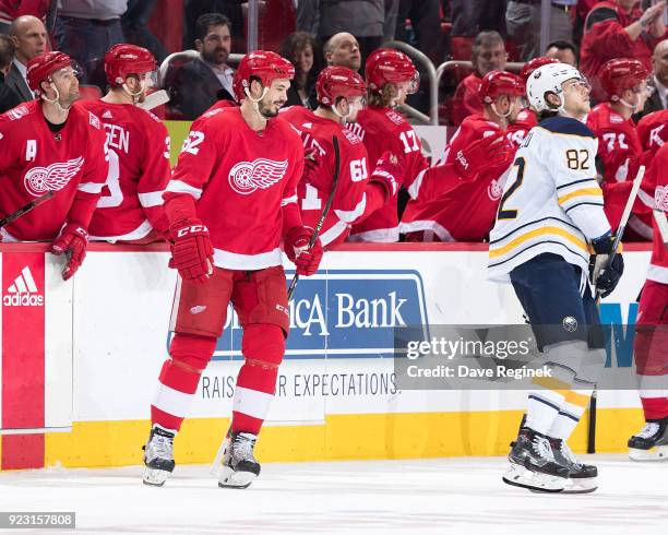 Jonathan Ericsson of the Detroit Red Wings gets done pounding gloves with teammates on the bench following his second period goal as Nathan Beaulieu...