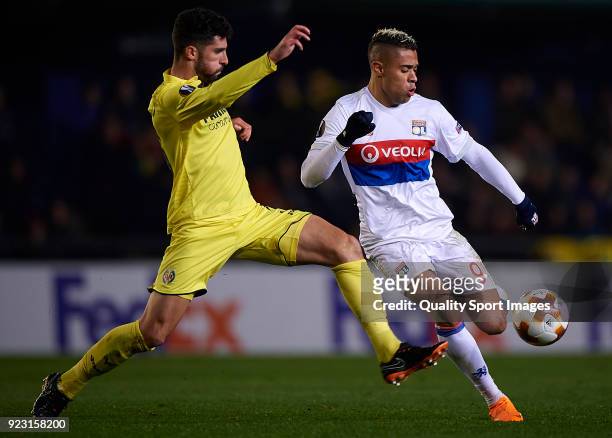 Alvaro Gonzalez of Villarreal competes for the ball with Mariano Diaz of Olympique Lyon during UEFA Europa League Round of 32 match between...