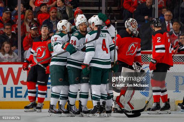 Mike Reilly of the Minnesota Wild celebrates his second period goal against Eddie Lack of the New Jersey Devils with teammate Matt Dumba on February...