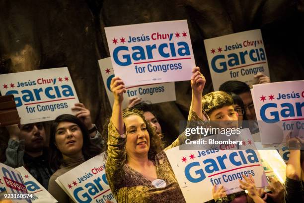 Attendees hold signs during a campaign rally for Jesus Garcia, Democratic U.S. House candidate from Chicago, not pictured, in Chicago, Illinois,...