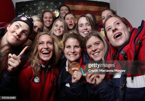 United States Snowboard gold medalist Jamie Anderson poses for a selfie with some members of the United States Women's Hockey Team and their gold...