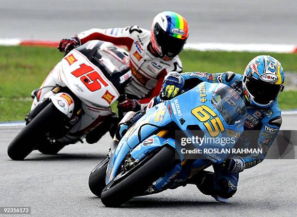Italian rider Loris Capirossi of Rizla Suzuki and Alex de Angelis of San Carlo Honda take a corner at the qualifying practice for the Malaysian...