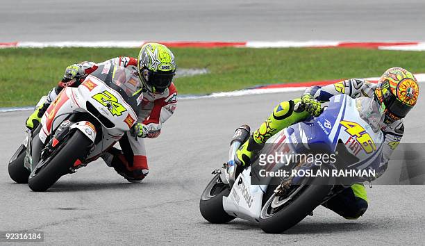 Italian rider Valentino Rossi of Fiat Yamaha and Spanish rider Toni Elias of San Carlo Honda take a corner in the qualifying practice for the...