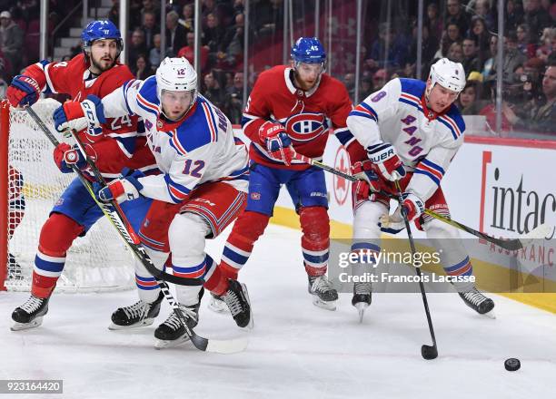 Phillip Danault and Joe Morrow of the Montreal Canadiens defend against Peter Holland Cody McLeod of the New York Rangers in the NHL game at the Bell...