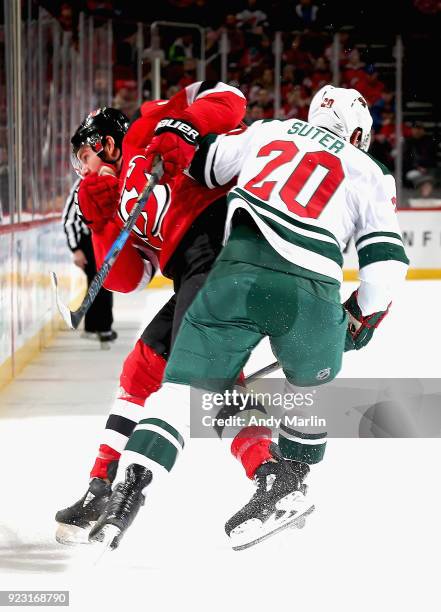 Jimmy Hayes of the New Jersey Devils and Ryan Suter of the Minnesota Wild battle for position during the game at Prudential Center on February 22,...