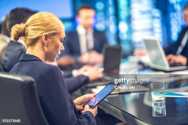 using smartphone during a meeting - hedge fund stock pictures, royalty-free photos & images