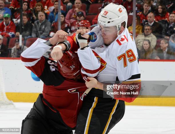 Micheal Ferland of the Calgary Flames and Zac Rinaldo of the Arizona Coyotes scuffle during the first period at Gila River Arena on February 22, 2018...