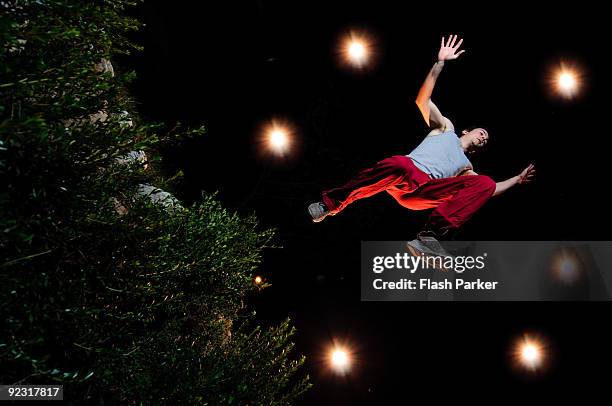 man jumps over hedge - jumping over hedge stock pictures, royalty-free photos & images