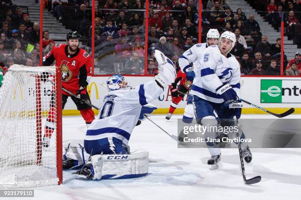 Louis Domingue of the Tampa Bay Lightning makes a glove save against Marian Gaborik of the Ottawa Senators as team mates Dan Girardi and Victor...