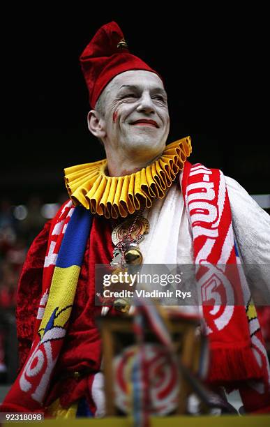 Mainz fan dressed up as a clown looks on ahead of the Bundesliga match between FSV Mainz 05 and SC Freiburg at Bruchweg Stadium on October 24, 2009...