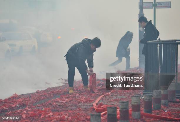 Merchant sets off firecrackers to pray for business booming in front of a wholesale market on February 23, 2018 in Harbin, Heilongjiang province of...