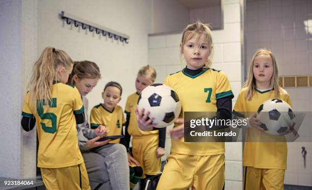young blonde female soccer player girl during football training - locker room stock pictures, royalty-free photos & images