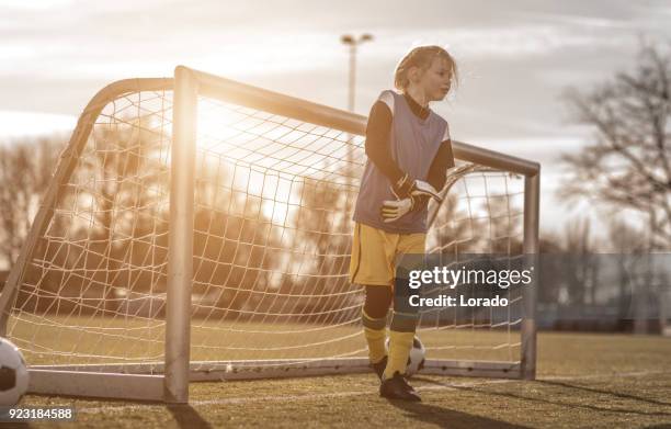 young blonde female soccer goalkeeper girl during football training - girl goalkeeper stock pictures, royalty-free photos & images