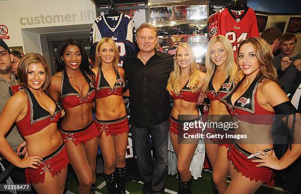 Legend Morten Andersen poses with the Tampa Bay Buccaneers Cheerleader squad during a Reebok NFL signing session at Foot Locker on Oxford Street on...