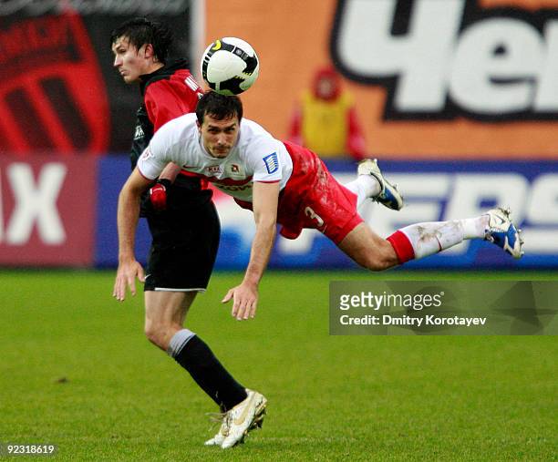 Anton Mamonov of FC Khimki fights for the ball with Martin Stranzl of FC Spartak Moscow during the Russian Football League Championship match between...