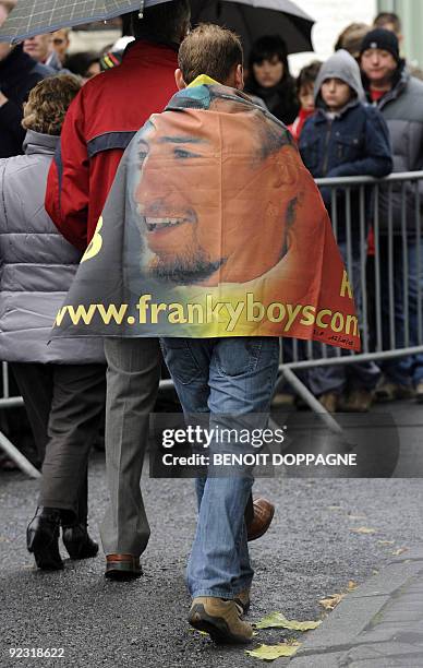 Fan wears is draped in a flag of the "FrankyBoys" the supporters club of Frank Vandenbroucke at a funeral ceremony for Belgian cyclist Frank...