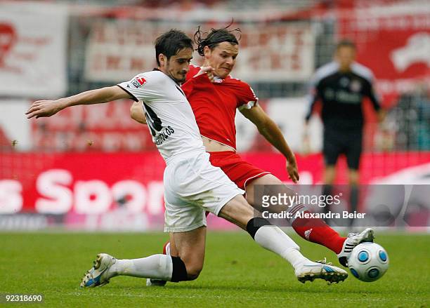 Daniel van Buyten of Muenchen fights for the ball with Nikos Liberopoulos of Frankfurt during the Bundesliga match between Bayern Muenchen and...