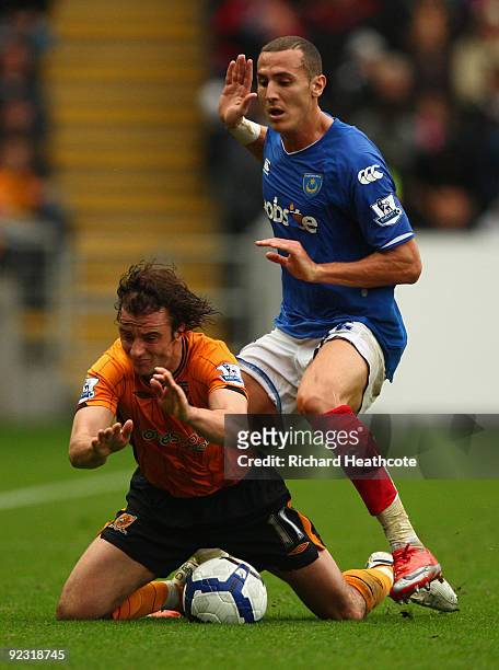 Hassan Yebda of Portsmouth tangles with Stephen Hunt of Hull City during the Barclays Premier League match between Hull City and Portsmouth at KC...