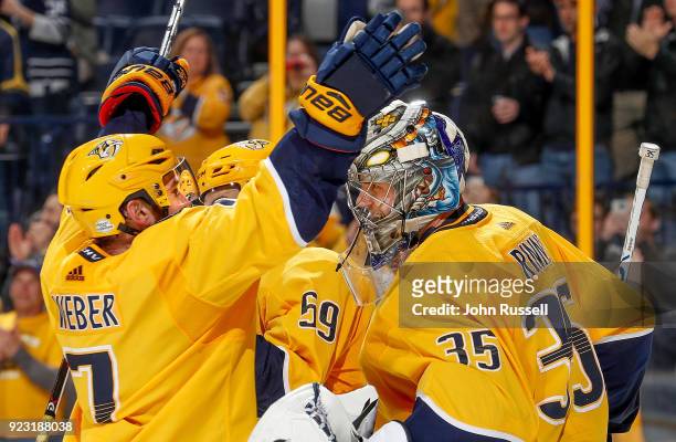 Yannick Weber congratulates Pekka Rinne of the Nashville Predators on his 300th career win after a 7-1 victory against the San Jose Sharks during an...