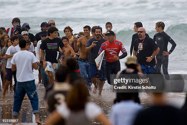 Kelly Slater of the United States of America sprints through the crowd after losing his round 2 heat to wildcard surfer Owen Wright during the Rip...