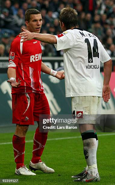Lukas Podolski of Koeln discusses with Thorben Marx of Moenchengladbach during the Bundesliga match between Borussia Moenchengladbach and 1. FC Koeln...