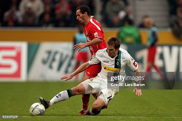 Petit of Koeln is challenged by Thorben Marx of Moenchengladbach during the Bundesliga match between Borussia Moenchengladbach and 1. FC Koeln at...