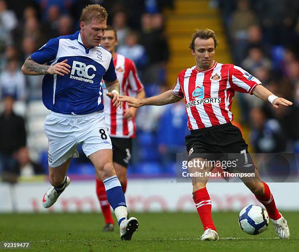 Garry O'Connor of Birmingham City tangles with Bolo Zenden of Sunderland during the Barclays Premier League match between Birmingham City and...
