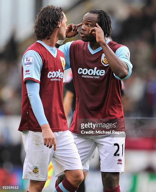 Andre Bikey and Chris Eagles of Burnley have words at half time during the Barclays Premier League match between Burnley and Wigan Athletic at Turf...