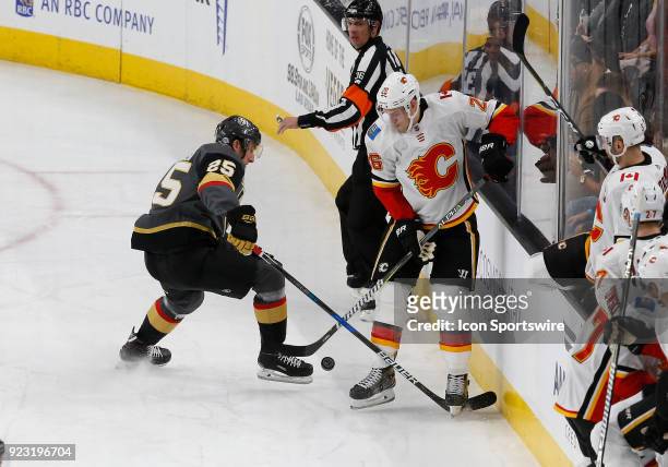 Vegas Golden Knights center Stefan Matteau and Calgary Flames defenseman Michael Stone battle for control of the puck during the first period of a...