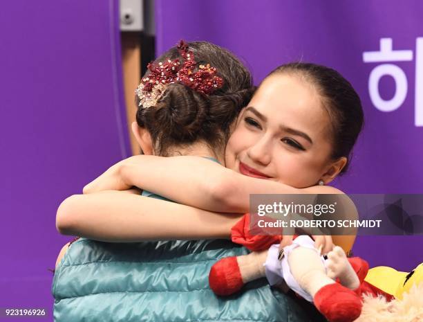 Russia's Alina Zagitova hugs Russia's Evgenia Medvedeva after the women's single skating free skating of the figure skating event during the...