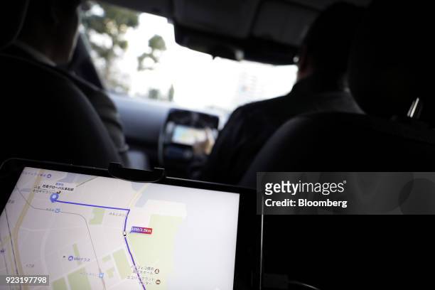 Tablet screen displays location tracking on a map during a test drive of the "Easy Ride" robot taxi service, jointly developed by Nissan Motor Co....