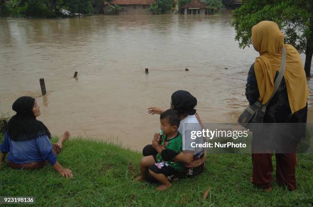 Residents fled on the edge of the highway as flood-stricken homes struck the village of Danareja, Brebes, Central Java In February, 23.2018. Hundreds...