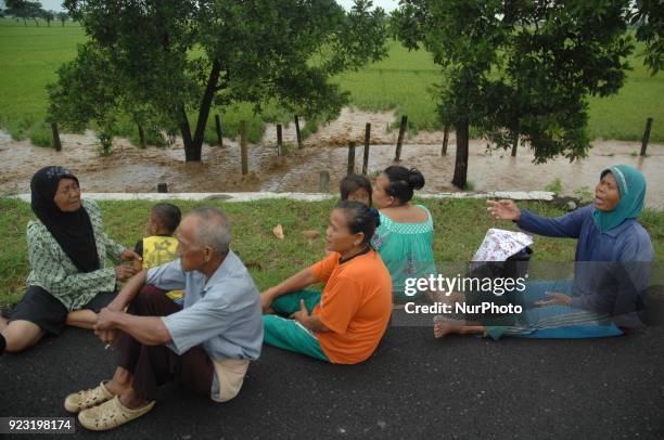 Residents fled on the edge of the highway as flood-stricken homes struck the village of Danareja, Brebes, Central Java In February, 23.2018. Hundreds...