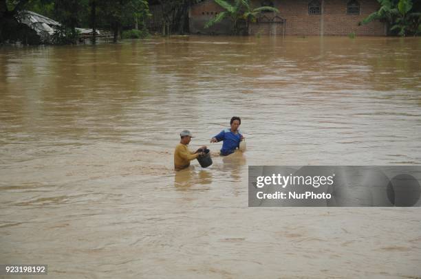 Residents cross the flood that struck the village of Danareja, Brebes, Central Java In February, 23.2018. Hundreds of homes and agricultural lands...