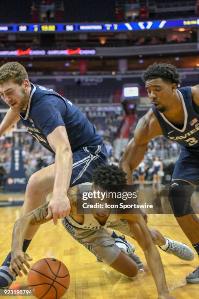 Georgetown Hoyas guard Jahvon Blair fights for a loose ball with Xavier Musketeers guard Quentin Goodin and forward Sean O'Mara on February 21 at the...