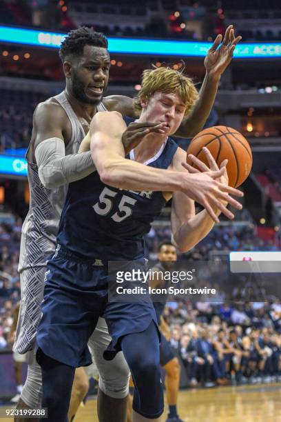 Georgetown Hoyas center Jessie Govan fights for a rebound with Xavier Musketeers guard J.P. Macura on February 21 at the Capital One Arena in...