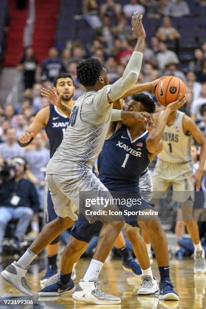 Xavier Musketeers guard Paul Scruggs is pressured by Georgetown Hoyas forward Marcus Derrickson on February 21 at the Capital One Arena in...