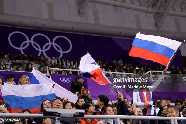 Fans wave Russian flags as Alina Zagitova of Olympic Athlete from Russia competes during the Ladies Single Skating Free Skating on day fourteen of...
