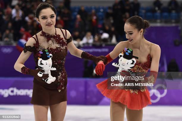 Silver medallist Russia's Evgenia Medvedeva and gold medallist Russia's Alina Zagitova attend the venue ceremony after the women's single skating...