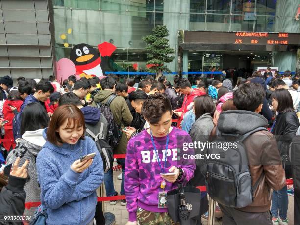 Employees of Chinese Internet giant Tencent queue up to get red envelops from Tencent Chairman and CEO Pony Ma Huateng at the headquarters of Tencent...