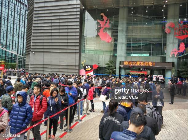 Employees of Chinese Internet giant Tencent queue up to get red envelops from Tencent Chairman and CEO Pony Ma Huateng at the headquarters of Tencent...